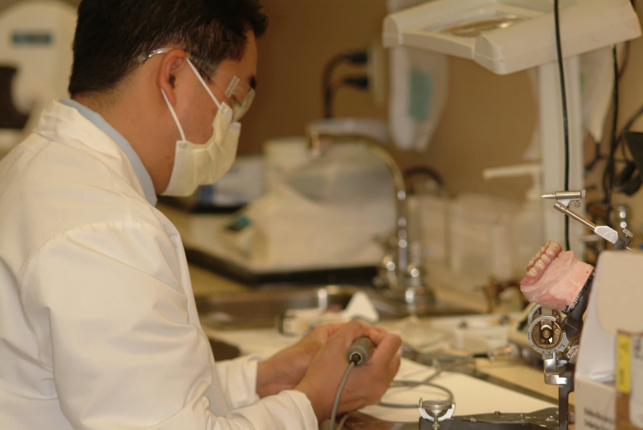 A prosthodontist crafting a dental restoration in the lab
